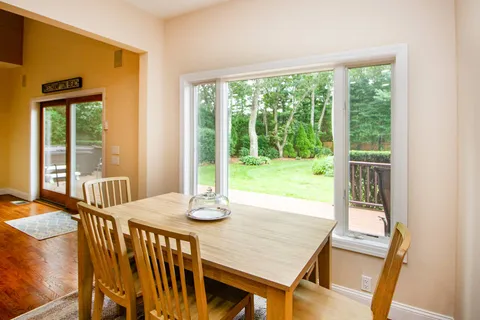 a view of a dining room with furniture window and wooden floor