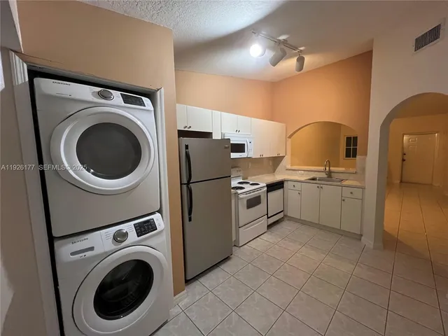 a kitchen with a sink a washer and dryer