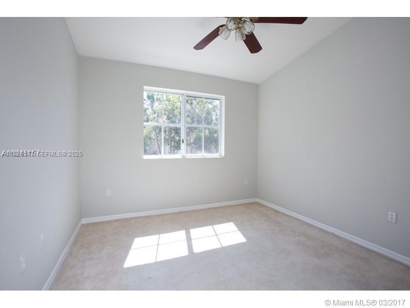 1251 Southeast 27th Street, Unit 204 Homestead, FL 33035 - Photo 6 of 11 a view of an empty room and window