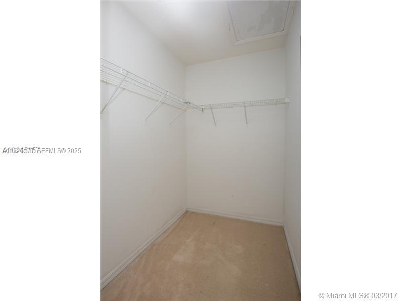 1251 Southeast 27th Street, Unit 204 Homestead, FL 33035 - Photo 7 of 11 a view of a room with racks on the wall