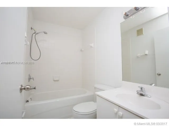 a bathroom with a toilet a sink and shower