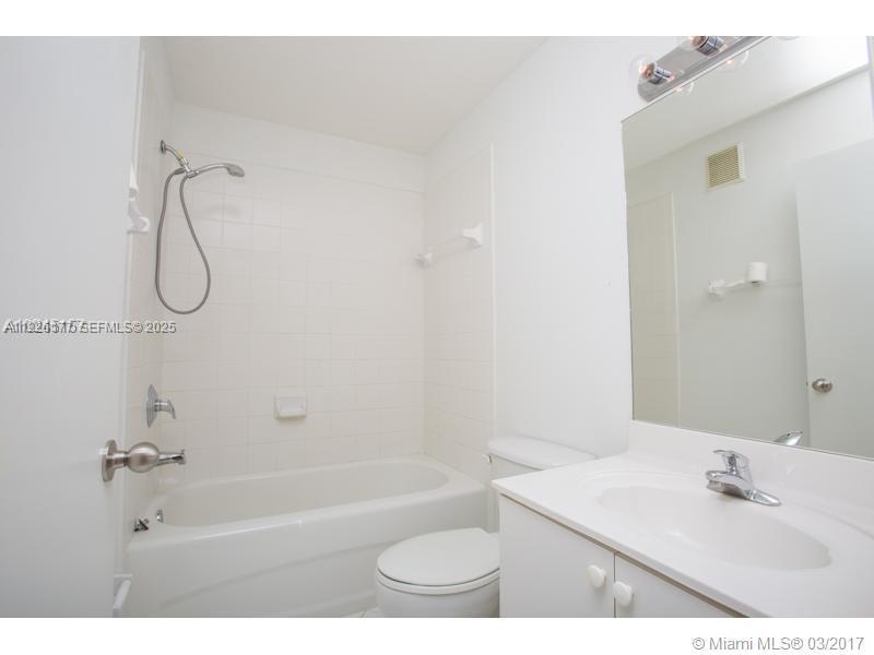 1251 Southeast 27th Street, Unit 204 Homestead, FL 33035 - Photo 9 of 11 a bathroom with a sink a toilet and a bathtub