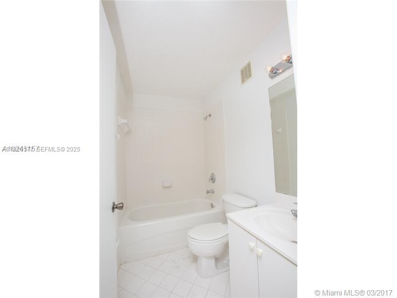 1251 Southeast 27th Street, Unit 204 Homestead, FL 33035 - Photo 10 of 11 a bathroom with a toilet a sink and shower