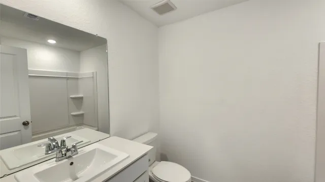a bathroom with a sink toilet and vanity