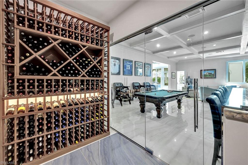 16770 Prato Way Naples, FL 34110 - Photo 11 of 29 a room with lots of wooden furniture and a table