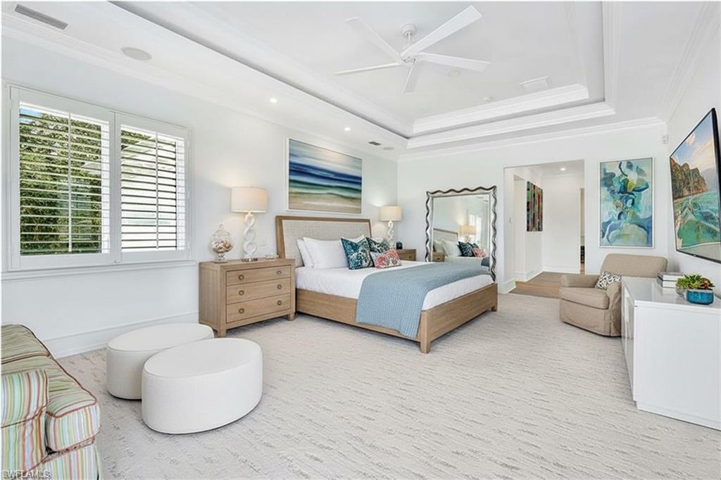 16770 Prato Way Naples, FL 34110 - Photo 13 of 29 a spacious bedroom with a bed a couch and large window