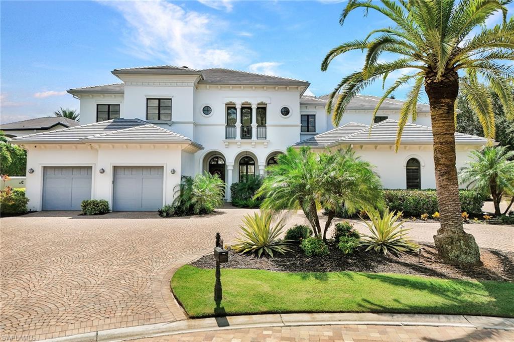 16770 Prato Way Naples, FL 34110 - Photo 29 of 29 a front view of a house with a yard and garage