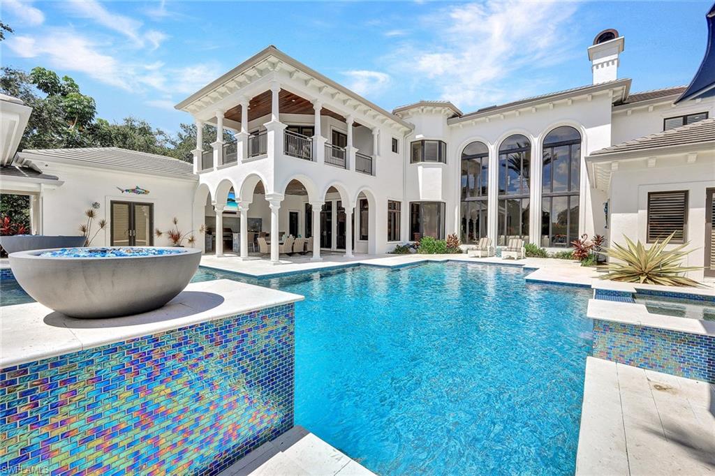 16770 Prato Way Naples, FL 34110 - Photo 3 of 29 a view of a house with pool and chairs