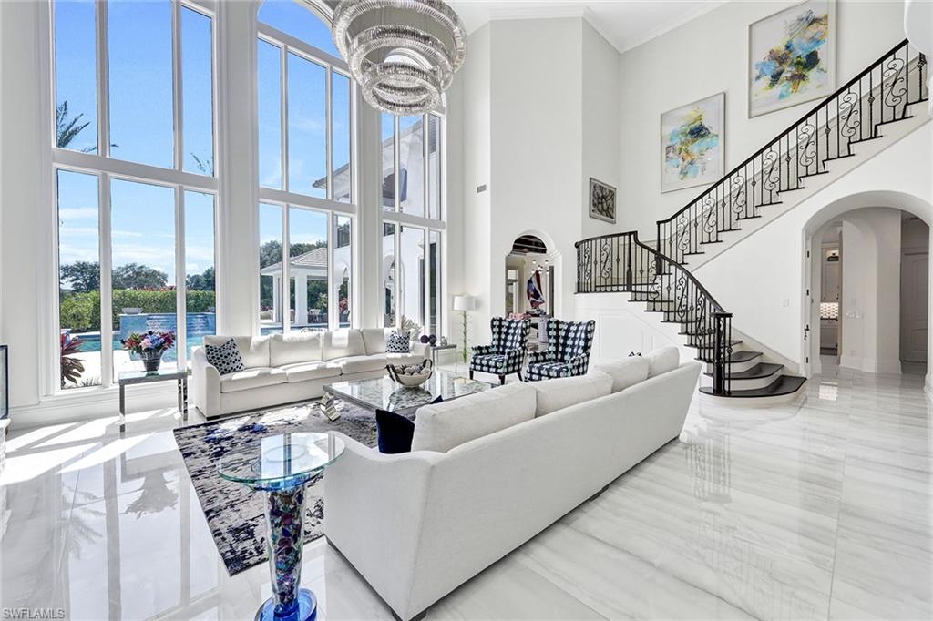 16770 Prato Way Naples, FL 34110 - Photo 4 of 29 a living room with patio furniture and a large window
