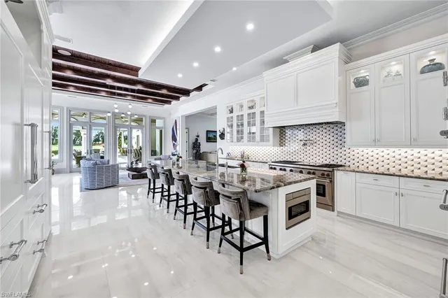 a kitchen with appliances a sink and cabinets