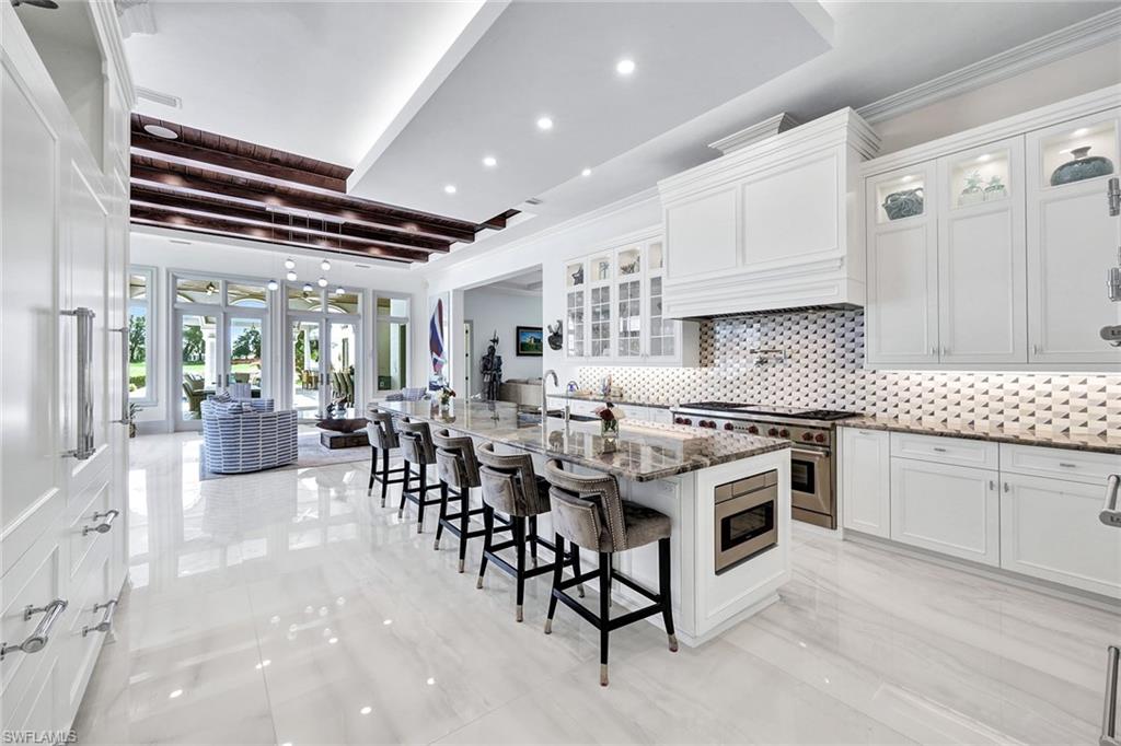 16770 Prato Way Naples, FL 34110 - Photo 6 of 29 a kitchen with appliances a sink and cabinets