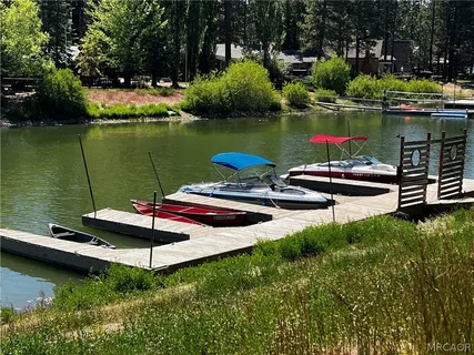 a lake view with a swimming pool and green space