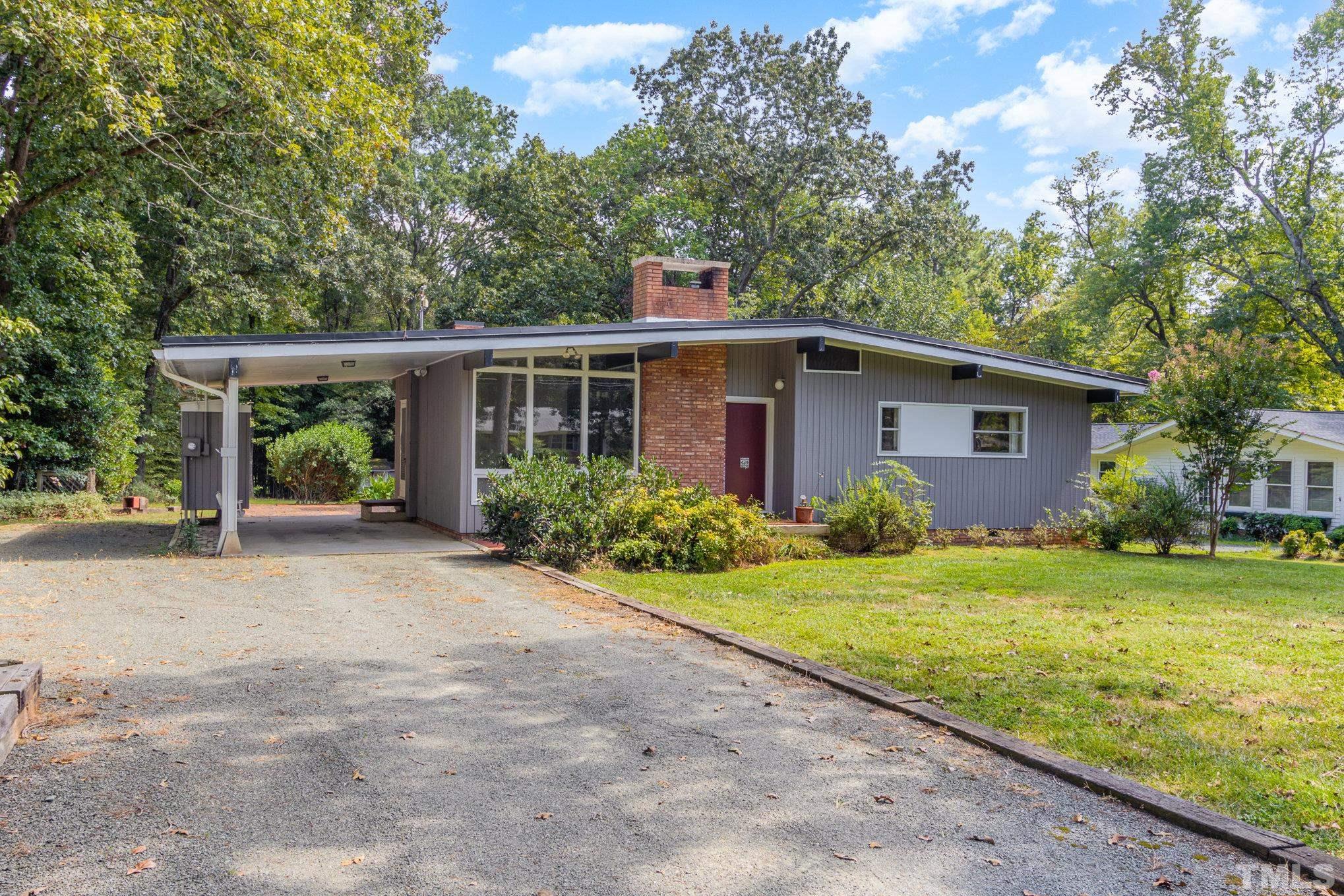 205 Simpson Street Carrboro, NC 27510 - Photo 1 of 27 a view of a house with backyard and garden