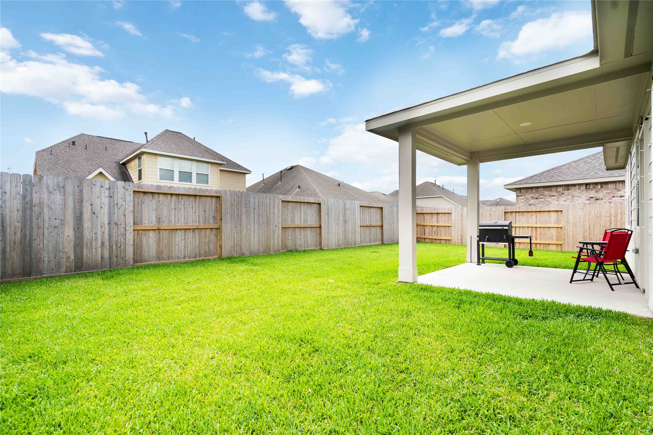8414 Bay Rdg Circle Baytown, TX 77523 - Photo 35 of 35 a view of a backyard with table and chairs and wooden fence