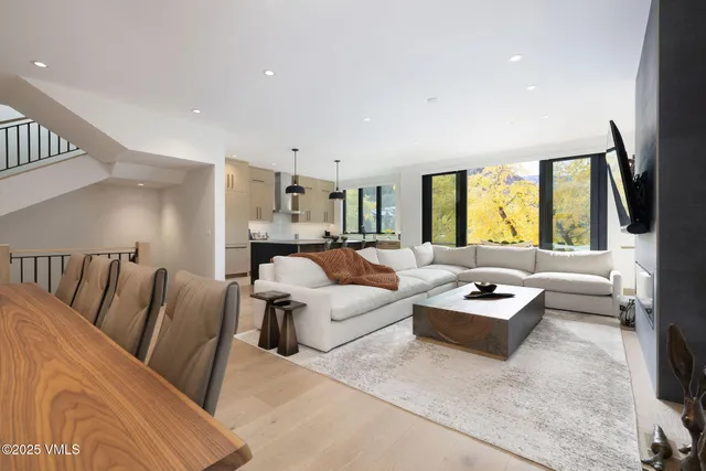 a living room with furniture fireplace and a large window