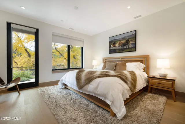 a bedroom with a bed and a large window