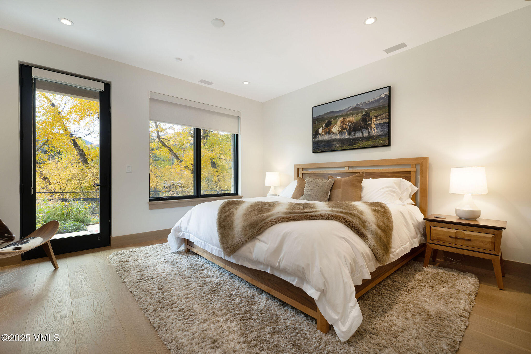 42 Riverfront Lane, Unit 2 Avon, CO 81620 - Photo 14 of 27 a bedroom with a bed and a large window