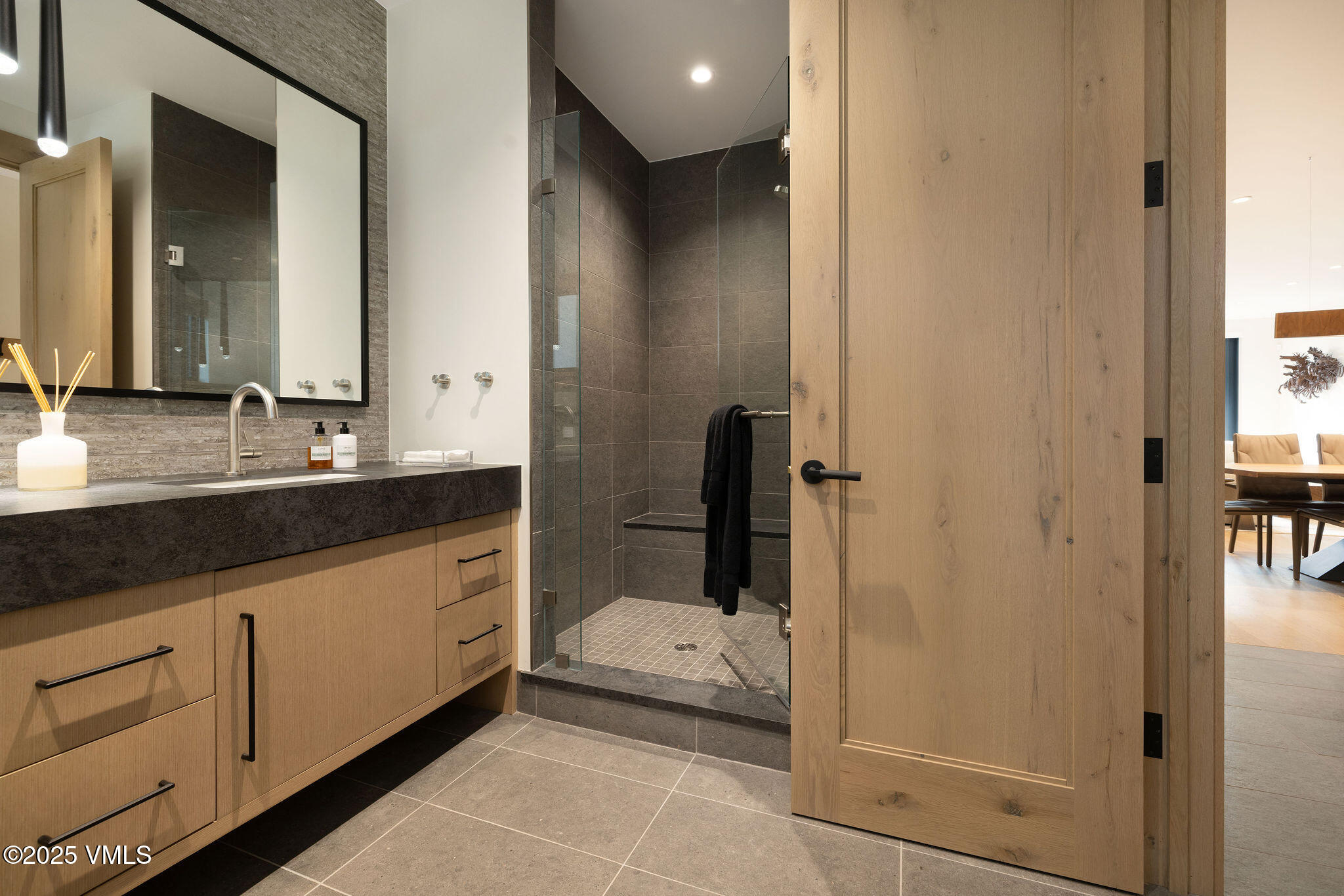42 Riverfront Lane, Unit 2 Avon, CO 81620 - Photo 18 of 27 a bathroom with a granite countertop sink a mirror and a bathtub