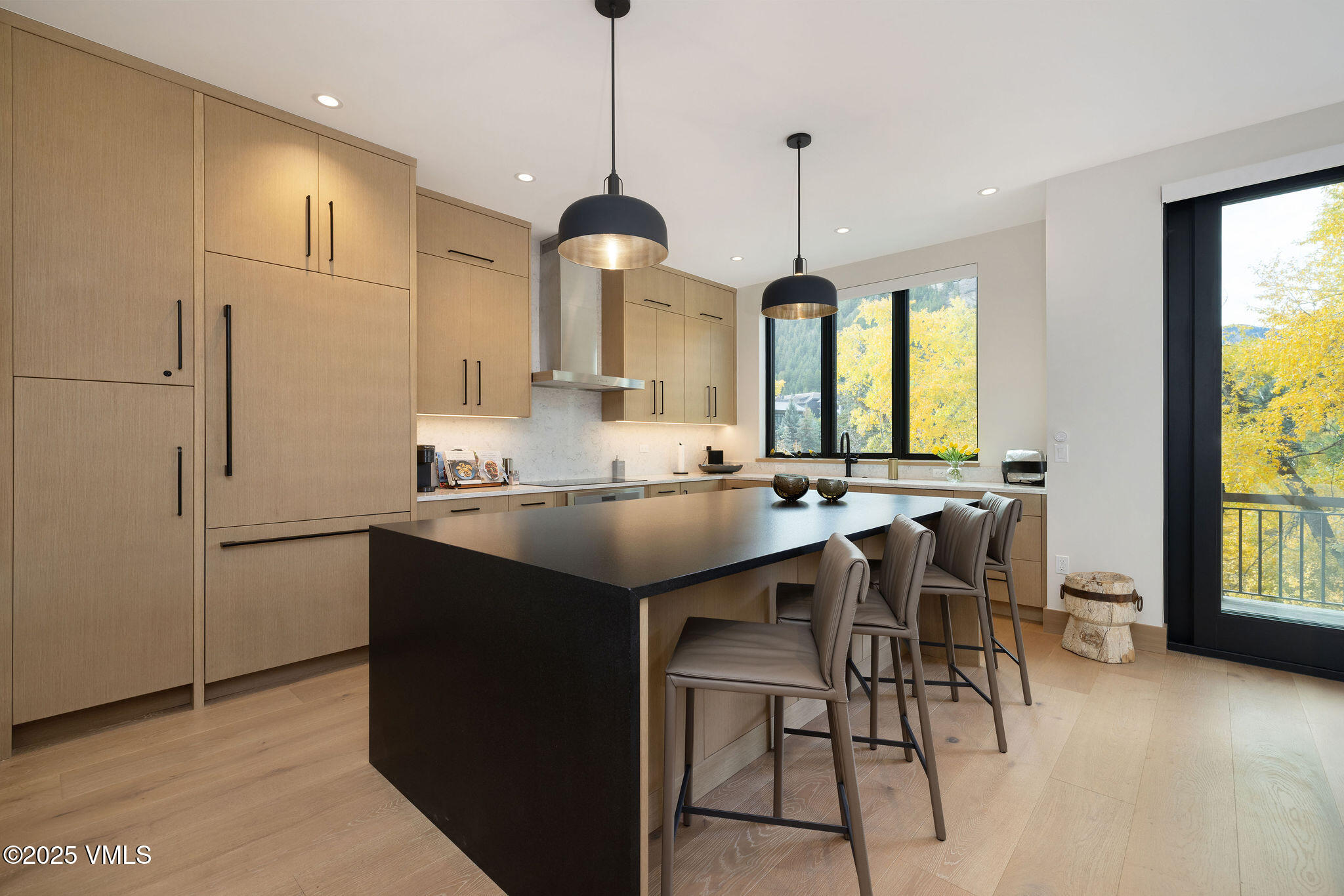 42 Riverfront Lane, Unit 2 Avon, CO 81620 - Photo 5 of 27 a kitchen with stainless steel appliances granite countertop a sink a stove a refrigerator and island with wooden floor