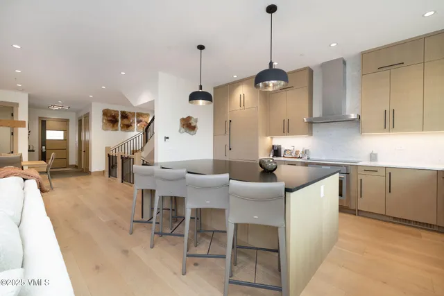 a large kitchen with a table and chairs