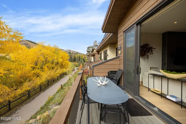 a balcony with table and chairs