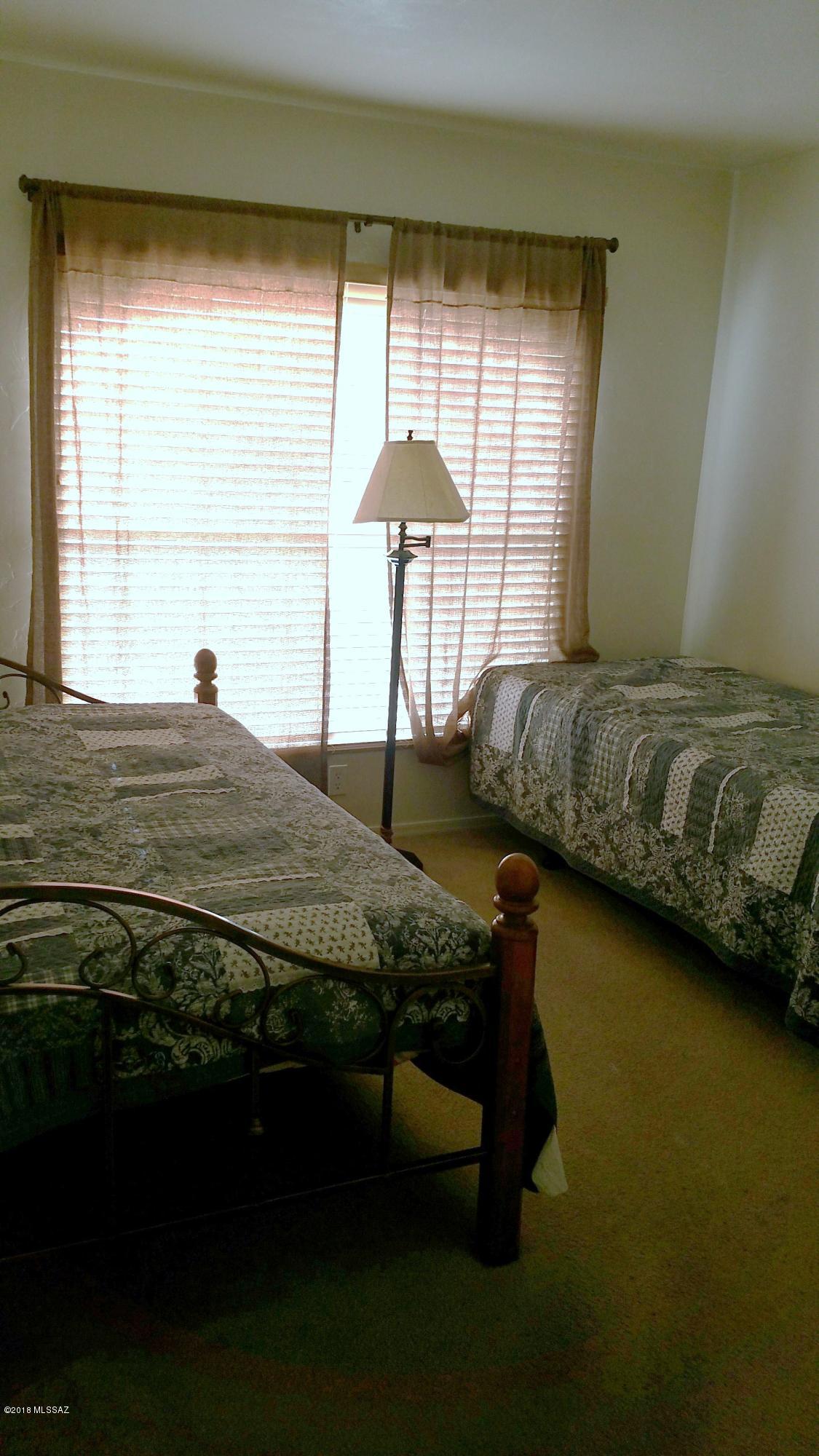 407 Willow Drive Rio Rico, AZ 85648 - Photo 15 of 15 a bedroom with a bed and a window