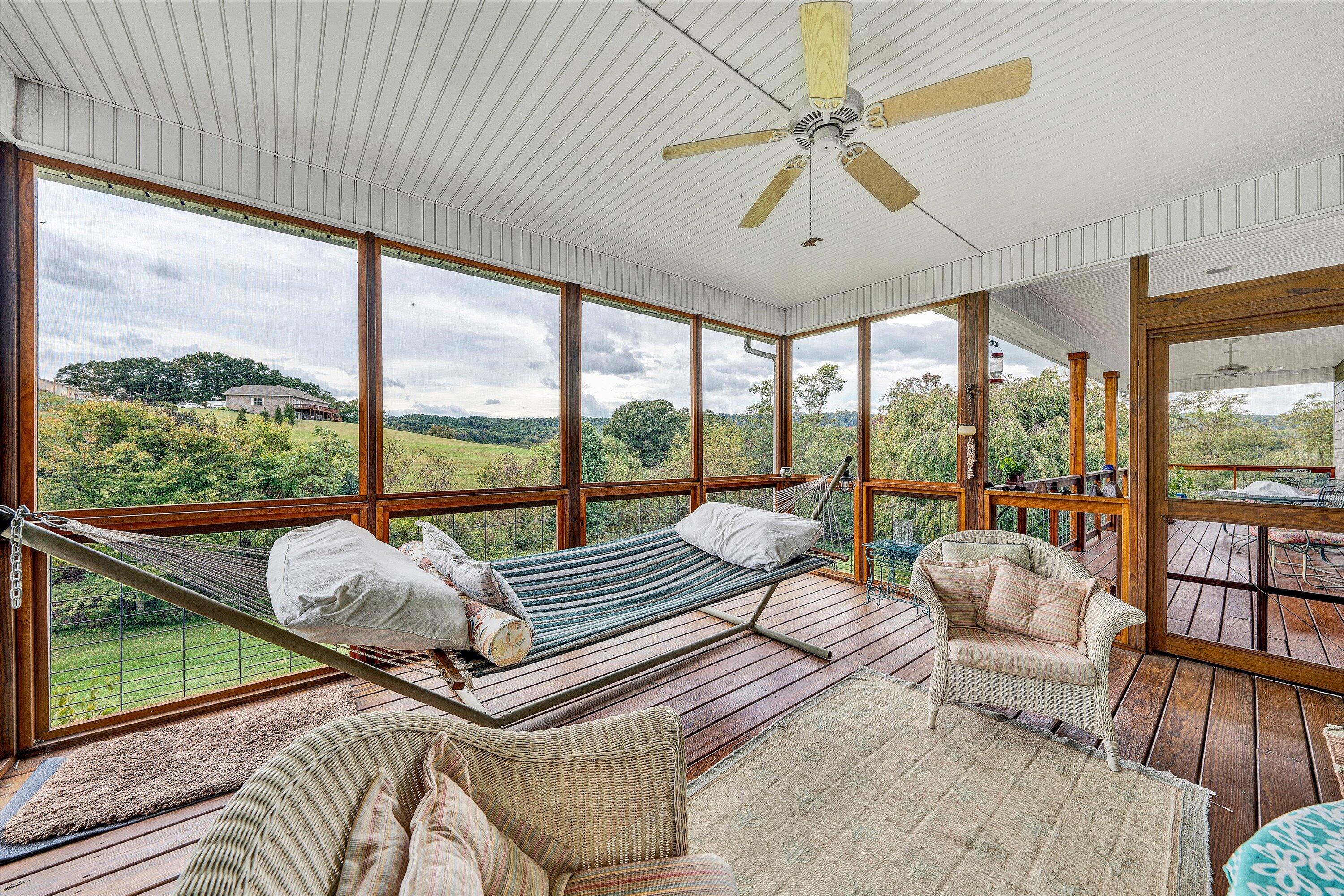 84 Green Level Road Boones Mill, VA 24065 - Photo 13 of 56 a living room with furniture and floor to ceiling windows