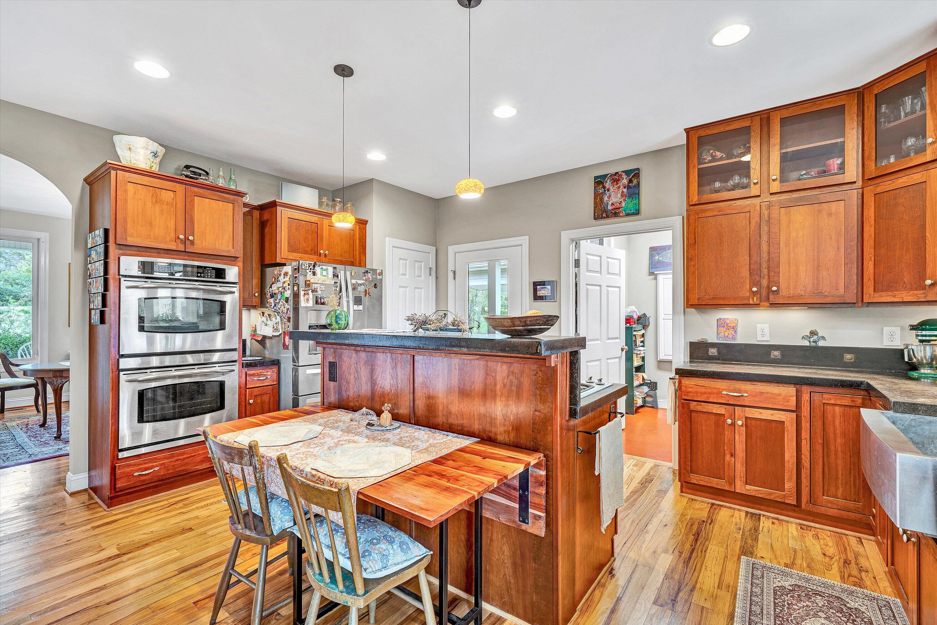 84 Green Level Road Boones Mill, VA 24065 - Photo 16 of 56 a kitchen with stainless steel appliances granite countertop a stove a refrigerator a kitchen island and chairs in it