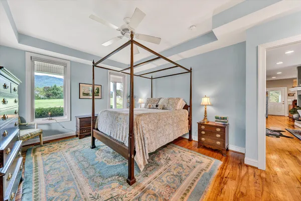 a bedroom with a bed window and walk in closet