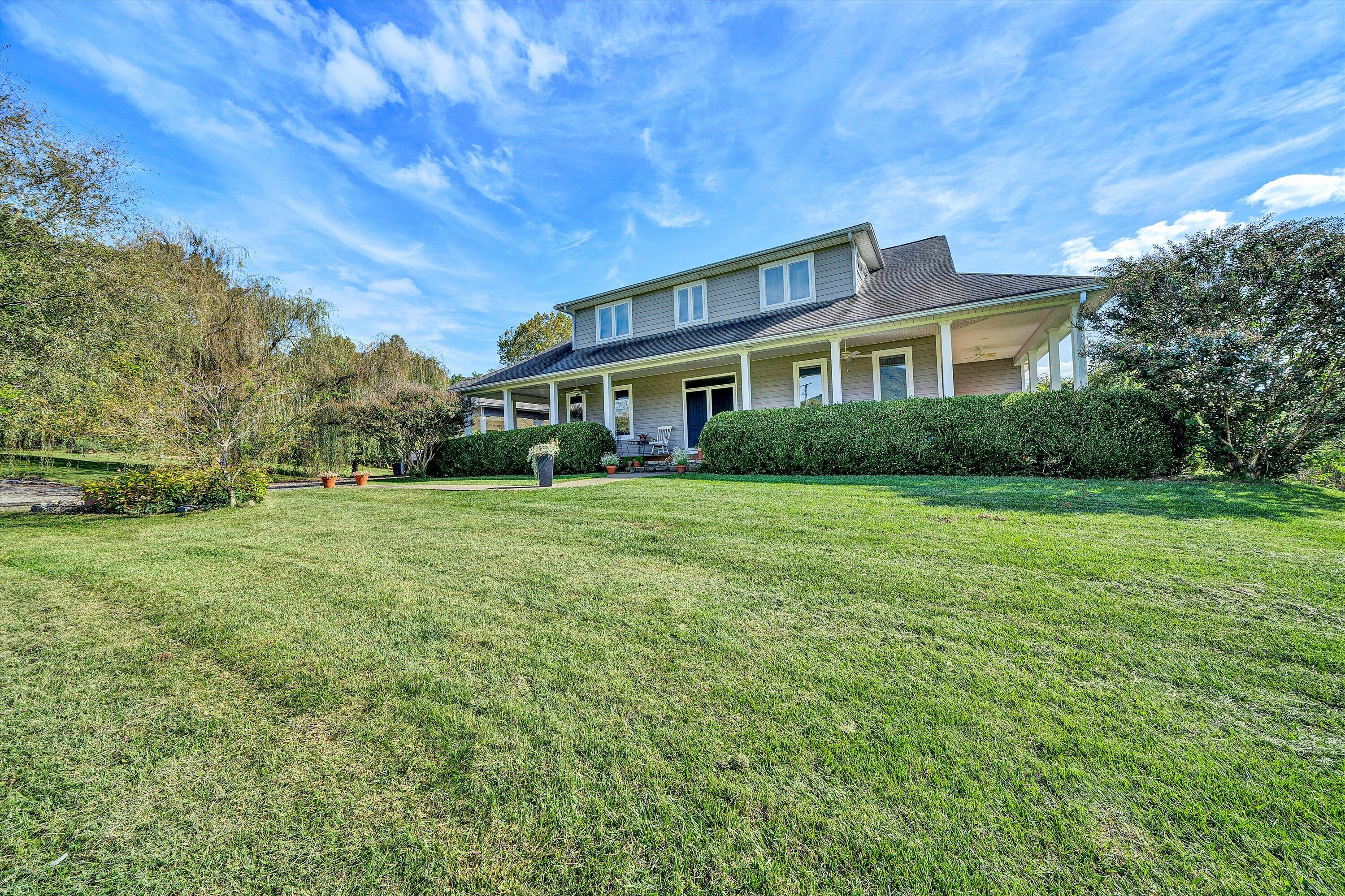 84 Green Level Road Boones Mill, VA 24065 - Photo 3 of 56 a front view of a house with a garden