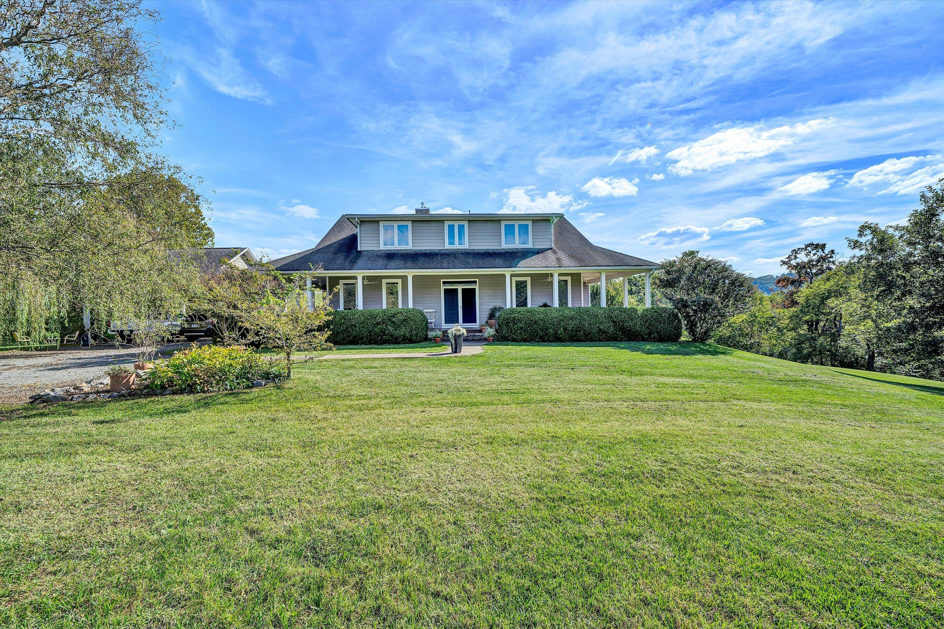 84 Green Level Road Boones Mill, VA 24065 - Photo 4 of 56 a front view of a house with a garden