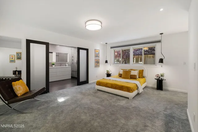 a spacious bedroom with a bed and a couch