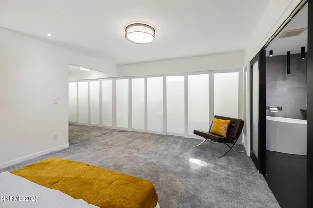 a view of a livingroom with wooden floor and furniture