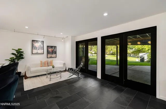 a living room with furniture and large windows