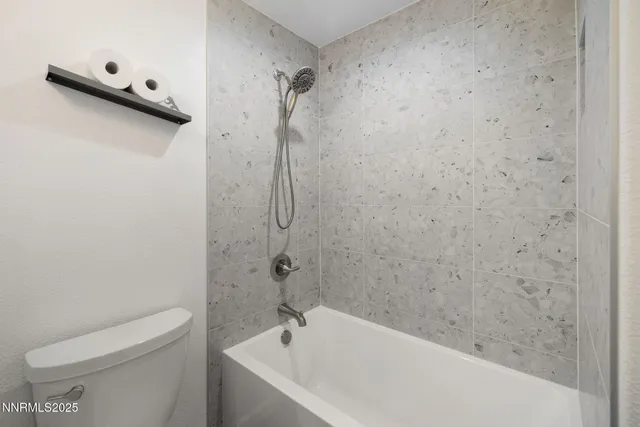 a bathroom with a bathtub and a toilet