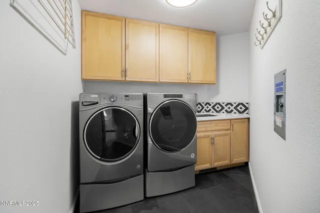 a utility room with sink dryer and washer