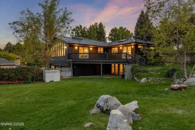 a view of a house with a yard and deck