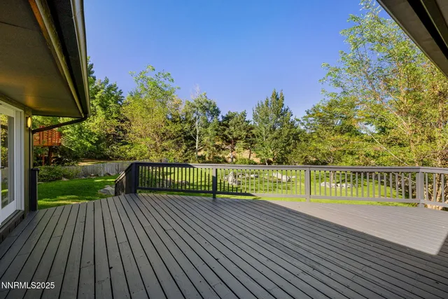 a view of balcony with wooden floor and fence