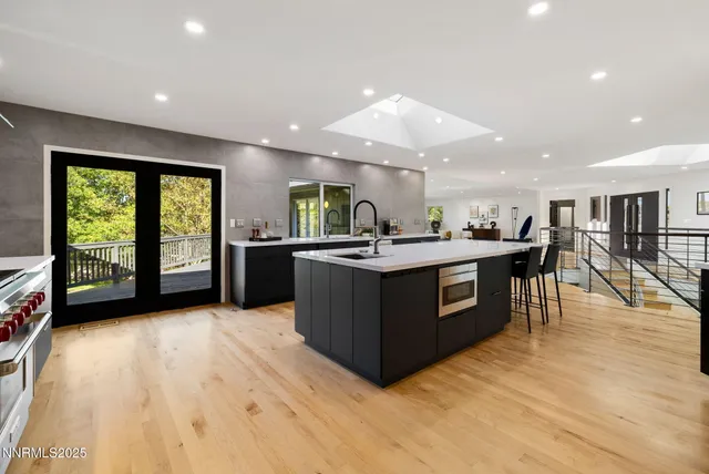a kitchen with a sink counter top space and stainless steel appliances