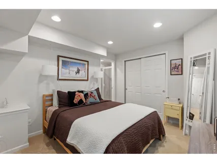 a bedroom with a bed and a painting