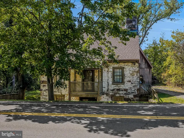 a view of street along with house and trees