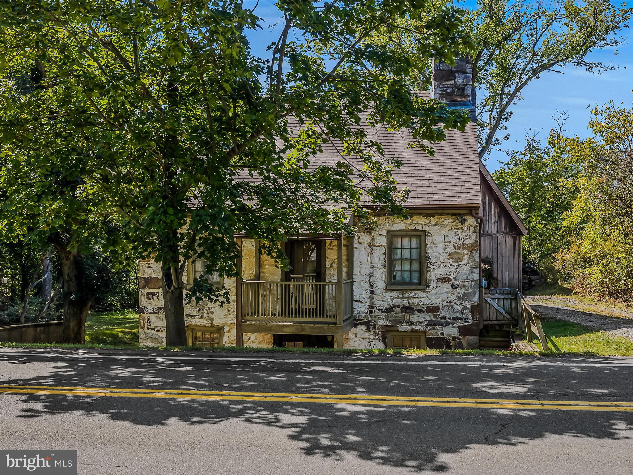 a view of street along with house and trees