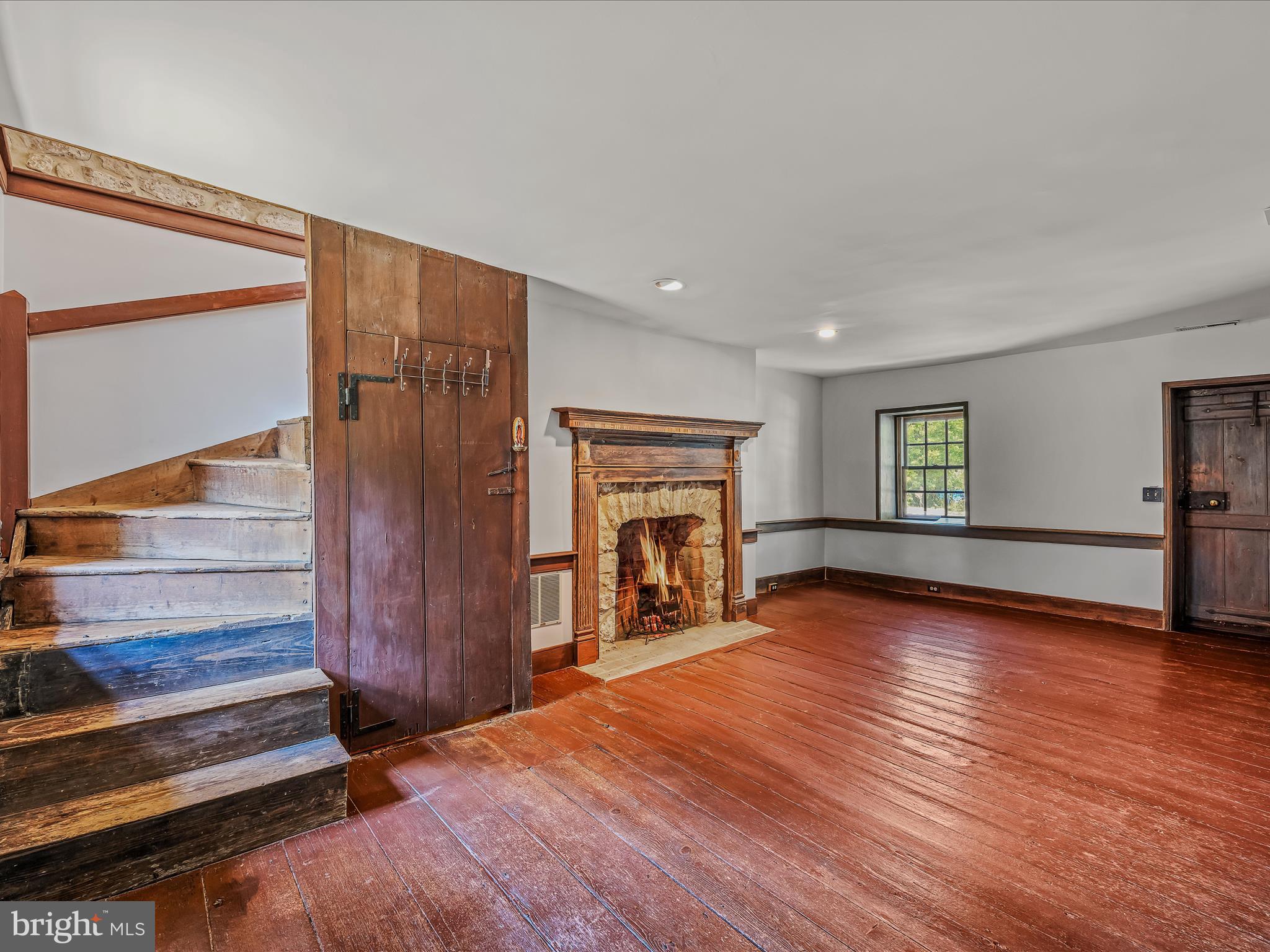 1646 Gerrardstown Road Gerrardstown, WV 25420 - Photo 5 of 37 a view of empty room with wooden floor and fireplace