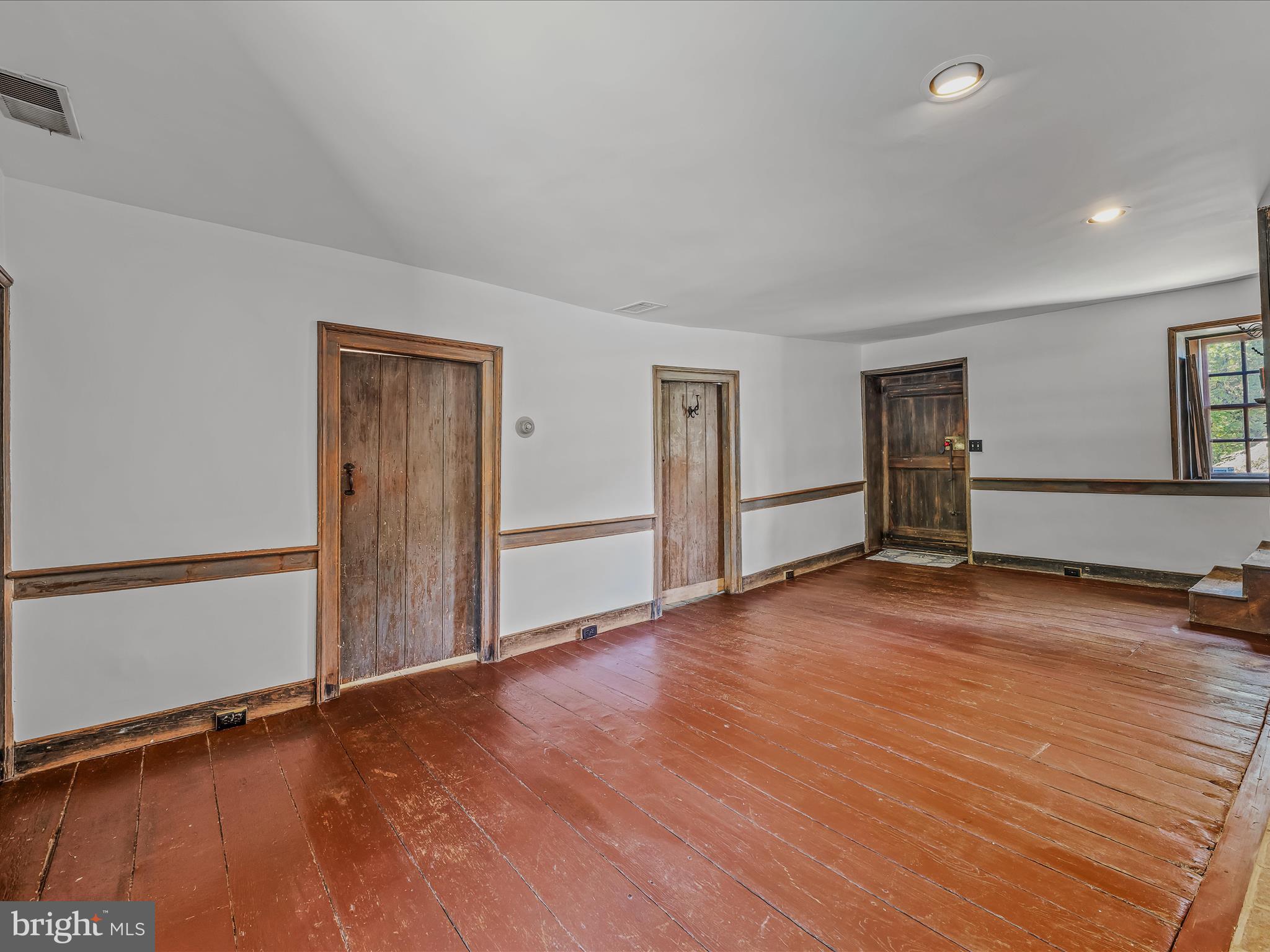 1646 Gerrardstown Road Gerrardstown, WV 25420 - Photo 7 of 37 a view of empty room with wooden floor and window