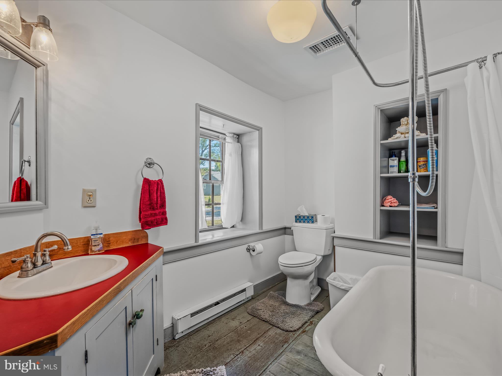 1646 Gerrardstown Road Gerrardstown, WV 25420 - Photo 10 of 37 a bathroom with a sink toilet vanity and tub