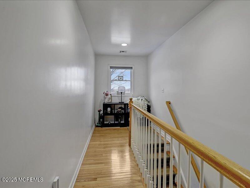 4 Knoll Terrace Hazlet, NJ 07730 - Photo 22 of 43 a view of a hallway with wooden floor and stairs