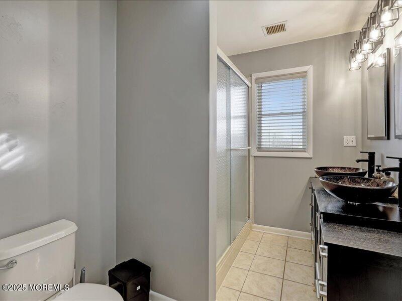 4 Knoll Terrace Hazlet, NJ 07730 - Photo 26 of 43 a bathroom with a toilet a sink a mirror and a window