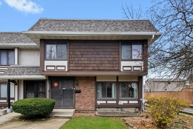 a view of a brick house with large windows