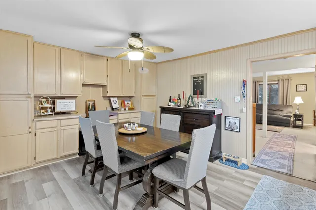 a view of a dining room with furniture and a chandelier