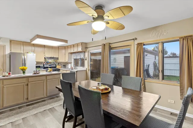 a kitchen with a table chairs and microwave